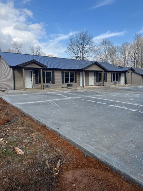 A building with a parking lot in front of it.