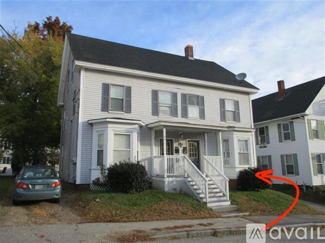 A house with a car parked in front of it.