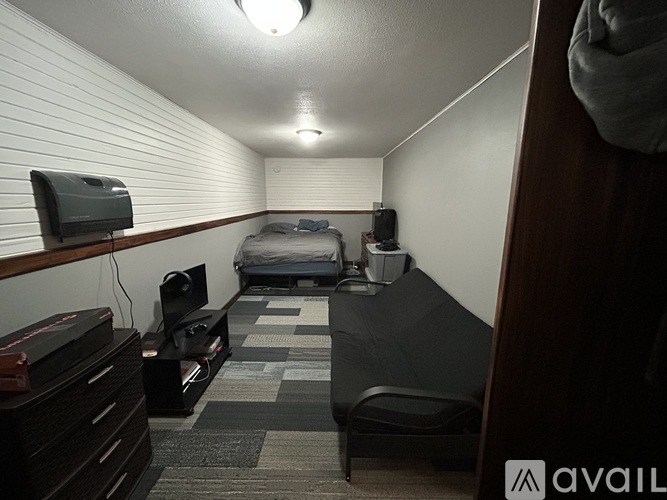 A hotel room with two beds and a desk.