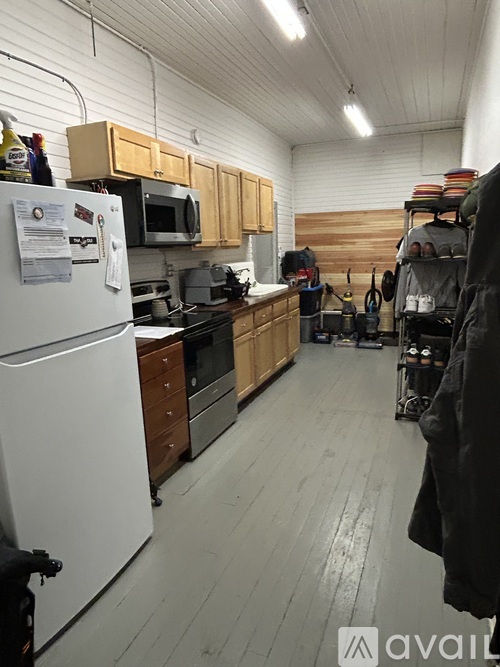 A kitchen with wooden cabinets and a white refrigerator.