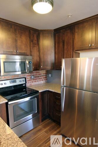 A kitchen with wooden cabinets and stainless steel appliances.