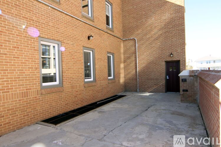 A brick building with a black door and windows.