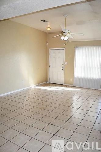 A room with a fan and a door.
