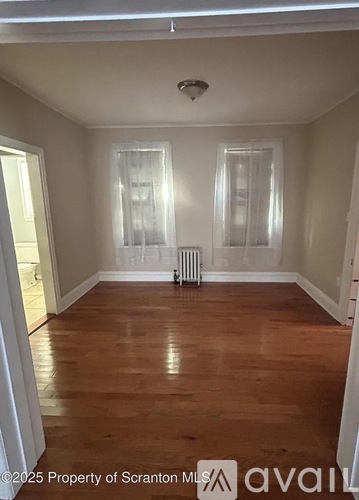A room with wooden floors and white walls.