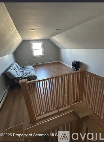 A living room with a couch and a television in a house.