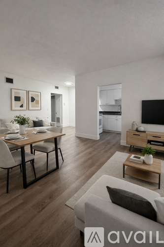 A modern living room with a dining table set for two.