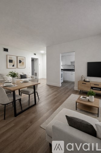 A modern living room with a dining table set for two.