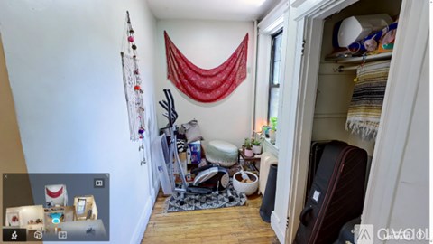 A room with a red curtain and a white wall.