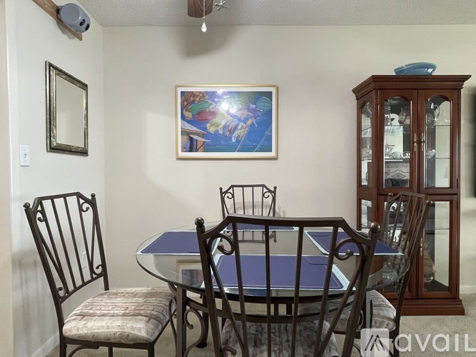 A dining room with a table and chairs.
