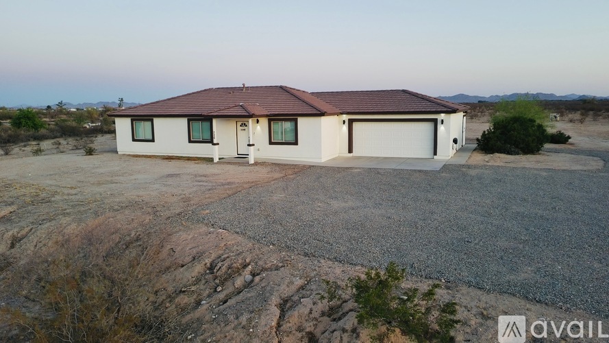 A house with a brown roof and a garage is available for sale.