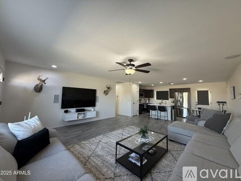 A living room with a grey couch and a black coffee table.