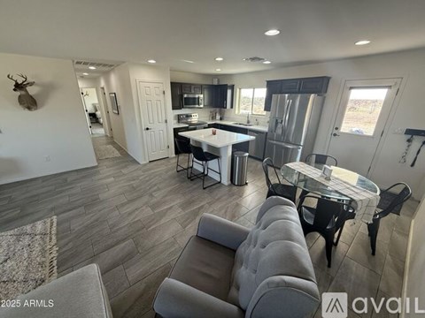 A modern kitchen with a dining table and chairs in the foreground.