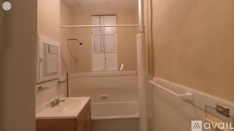 A bathroom with a tub, sink, and shower.