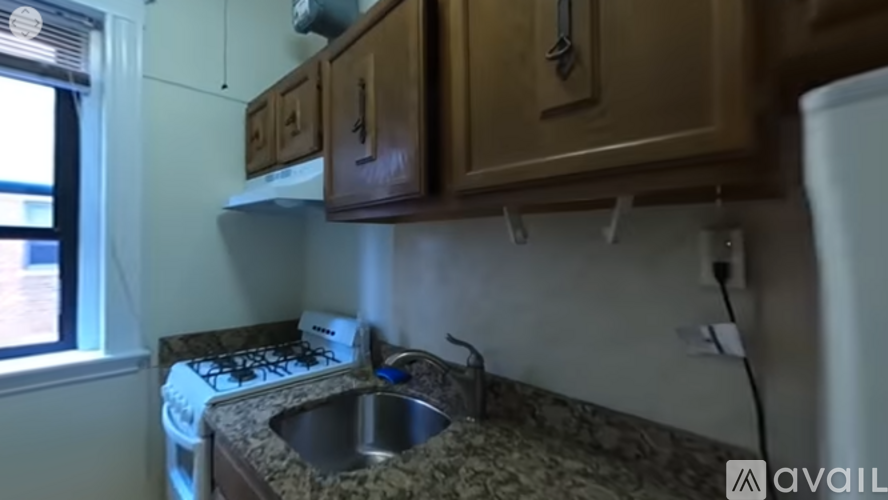 A kitchen with a sink and a stove top.