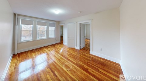 A room with wooden floors and white walls.
