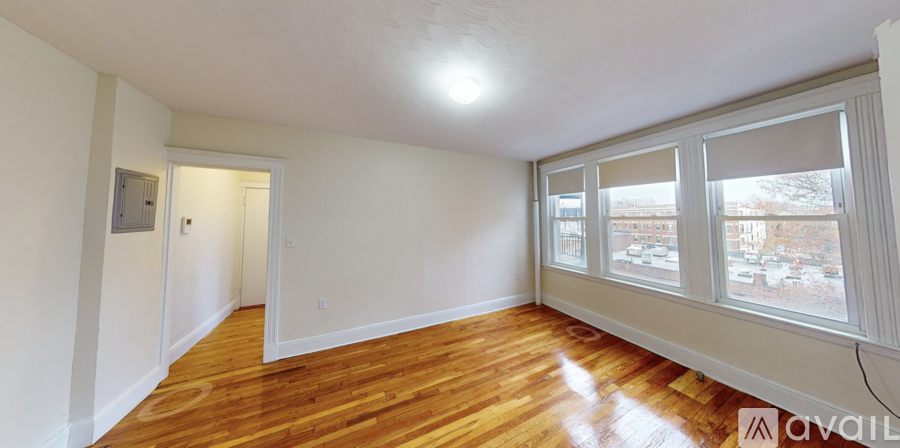 A room with wooden floors and white walls.