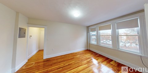 A room with wooden floors and white walls.
