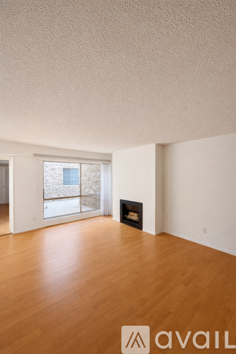 A room with wooden floors and a fireplace.