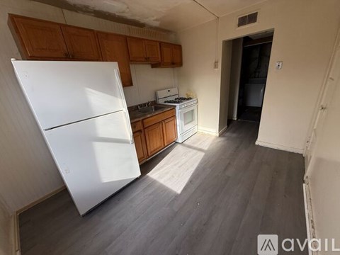 A white bathroom with a toilet, sink, and tub.