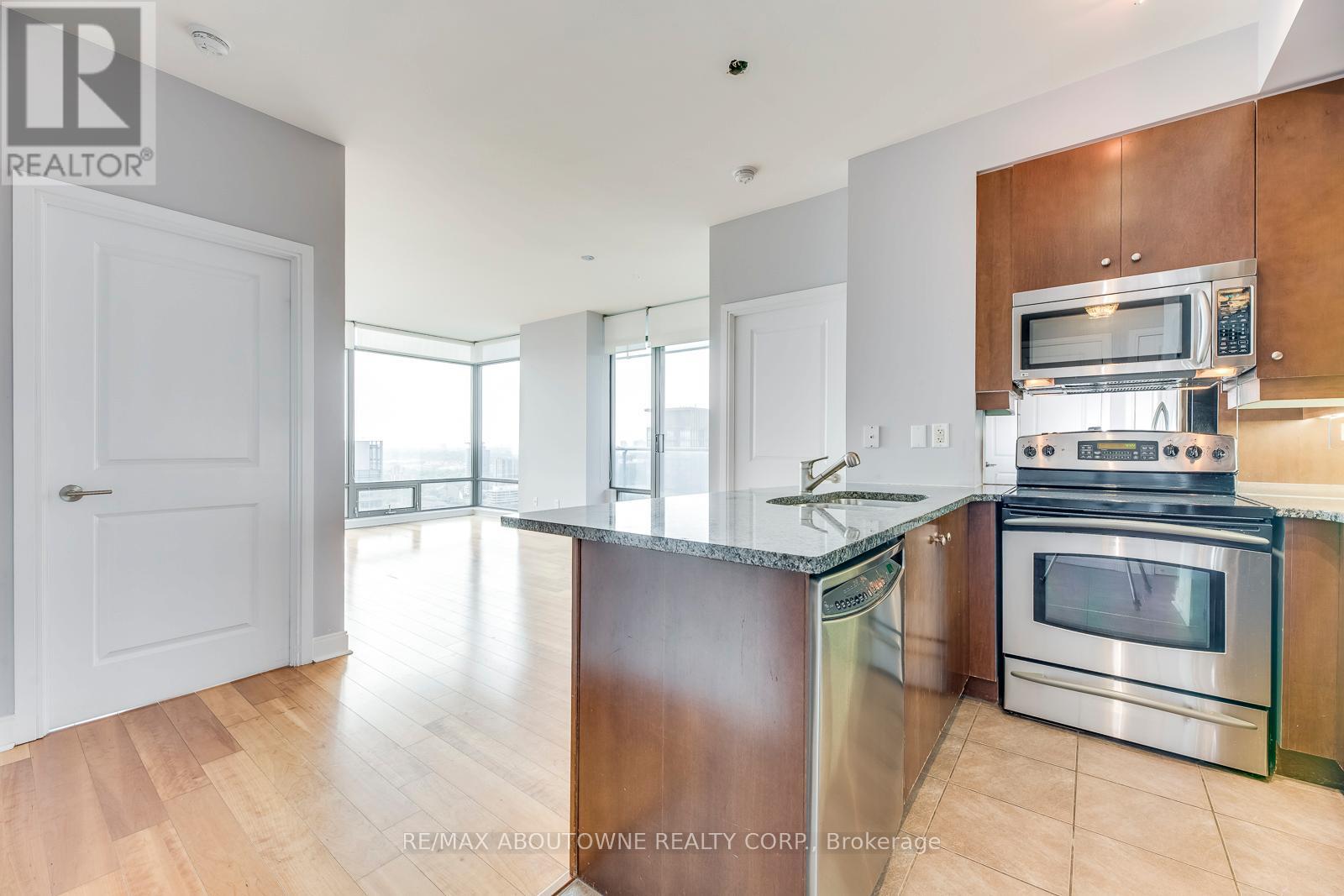 A modern kitchen with wooden cabinets and stainless steel appliances.