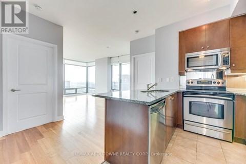 A modern kitchen with wooden cabinets and stainless steel appliances.