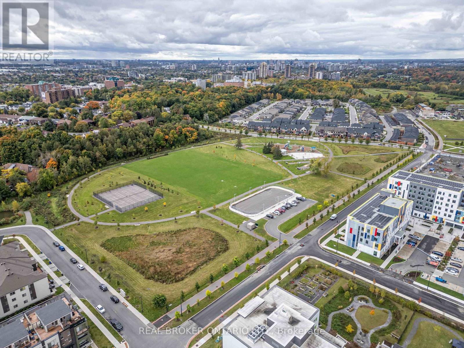 A bird's eye view of a city with a large green space in the foreground.