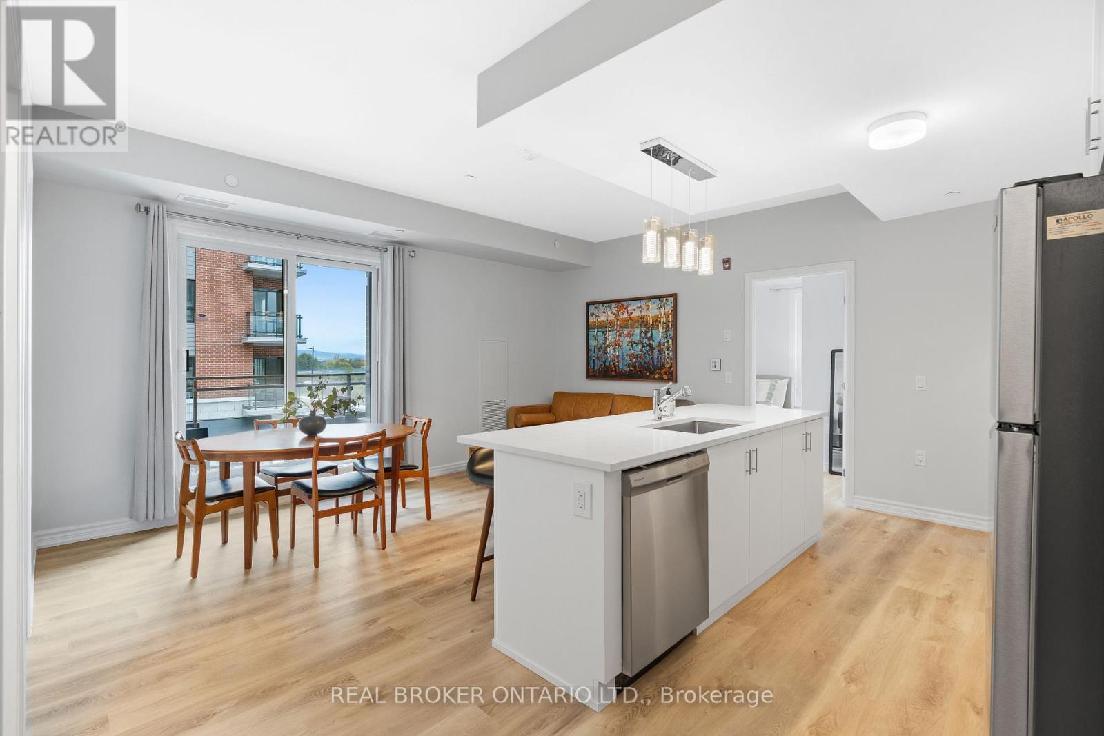 A kitchen with a dining table and chairs in a room with a sliding glass door.