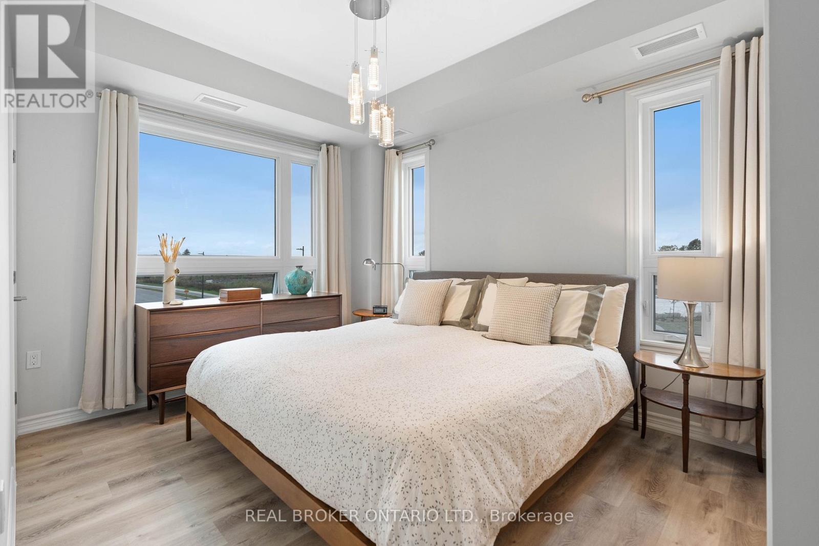 A bedroom with a large bed and a view of the beach.