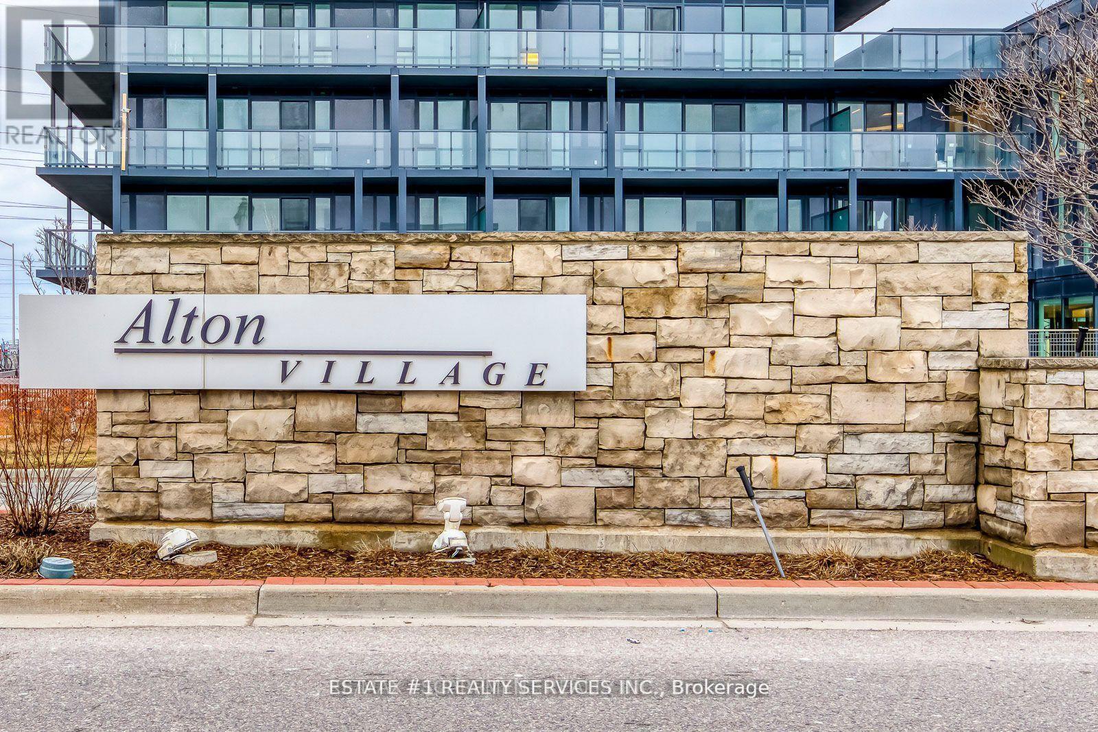 A sign that says Alton Village in front of a building.