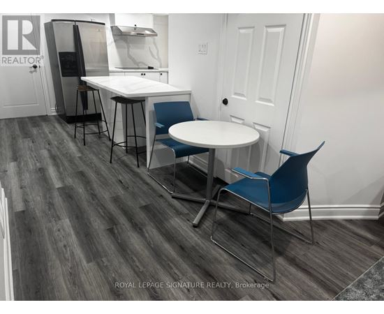 A dining area with a white table and blue chairs.
