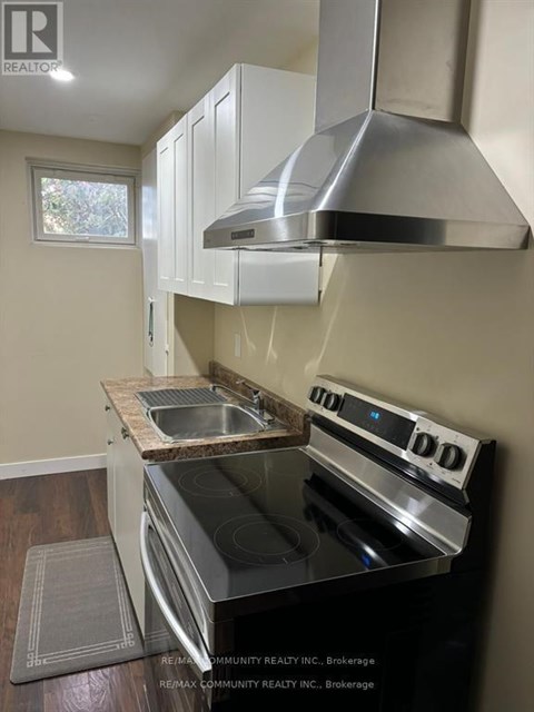 A modern kitchen with a stove top oven and a range hood.