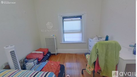 A room with a bed, a window, a radiator, and a washing machine.