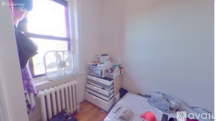 A small bedroom with a bed, dresser, and window.