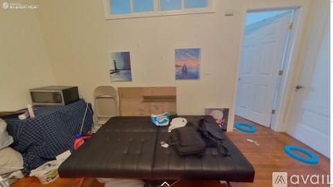 A room with a bed, a couch, and a TV.