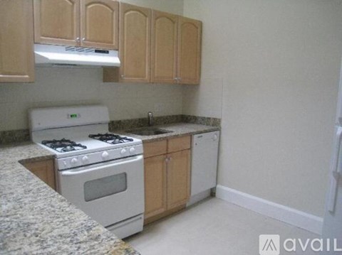 A kitchen with a stove and cabinets.