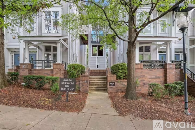 A white two-story building with a blue door and a sign that says "Private Residence No Trespassing".
