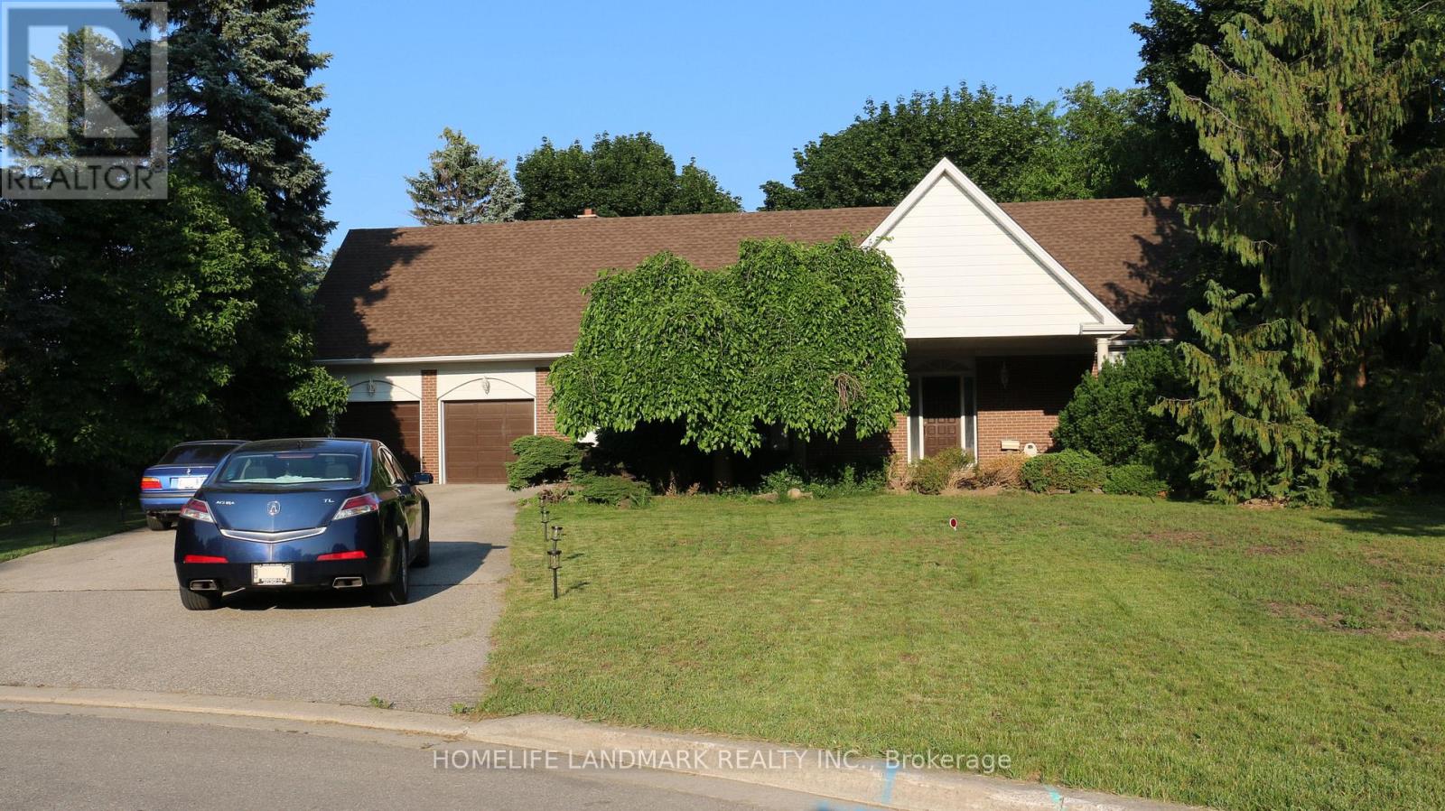 A blue car is parked in front of a house.