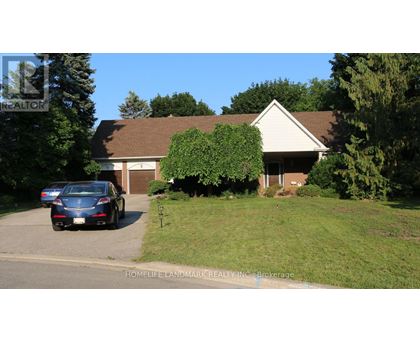 A blue car is parked in front of a house.