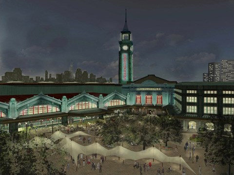 A large building with a clock tower is surrounded by trees and people are walking around.