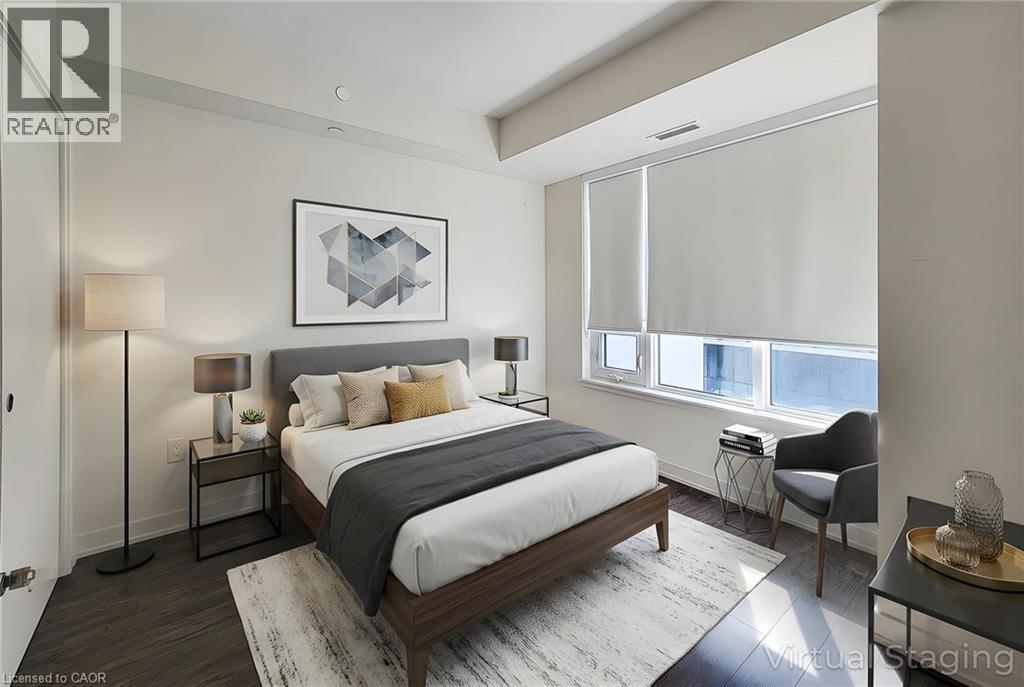 A bedroom with a large bed and a chair by the window.