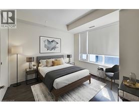 A bedroom with a large bed and a chair by the window.