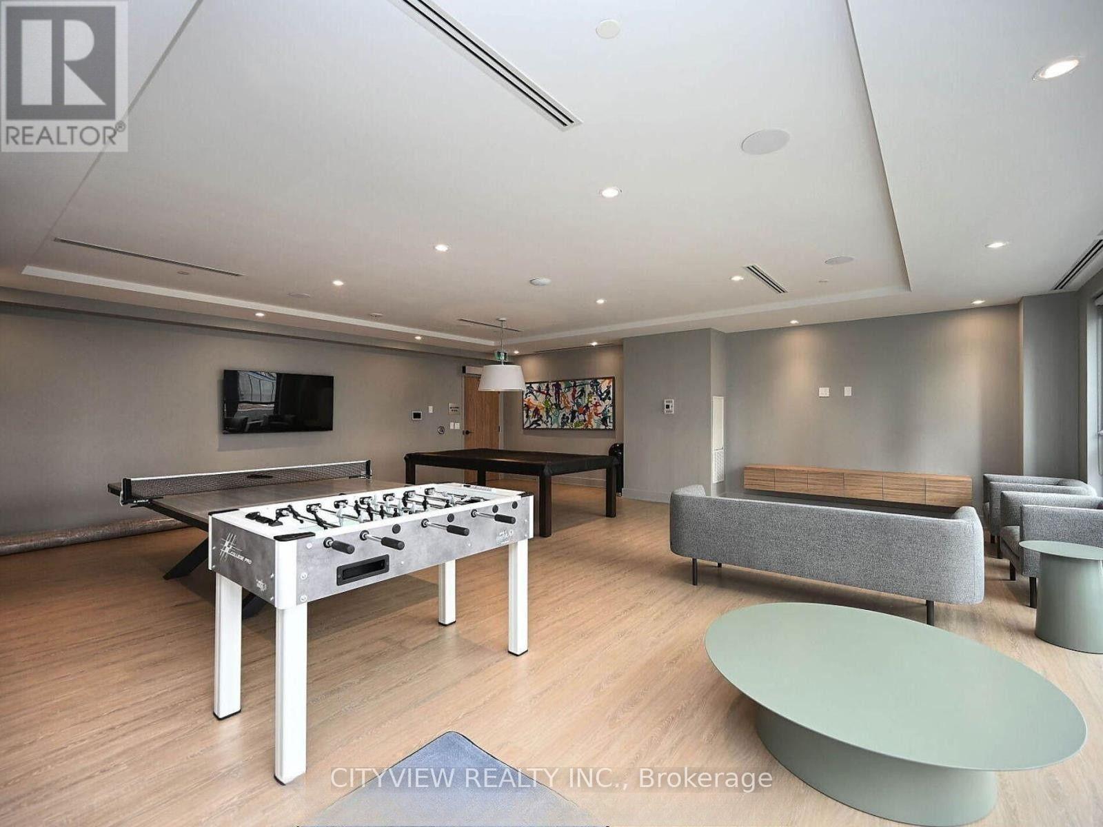 A pool table in a room with a couch and a coffee table.