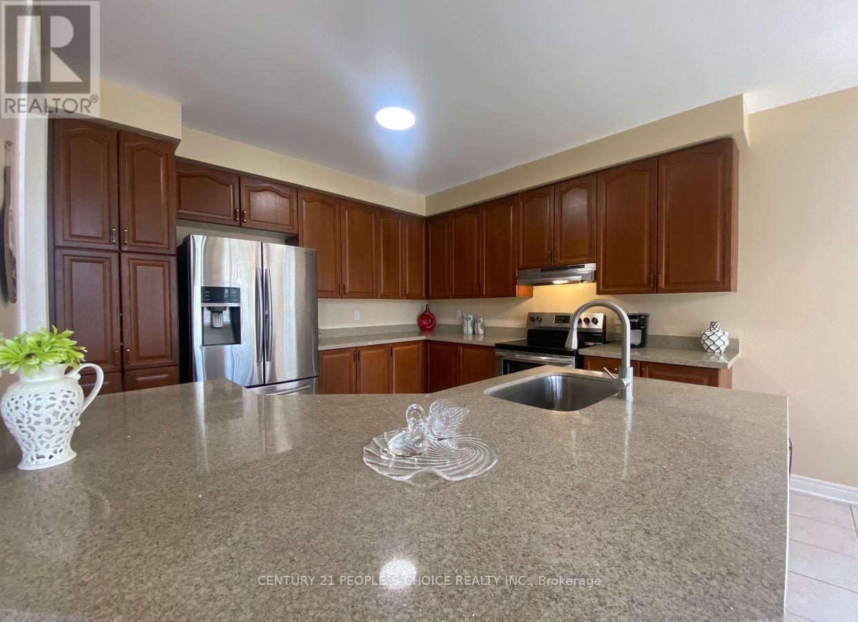 A kitchen with brown cabinets and a granite countertop.