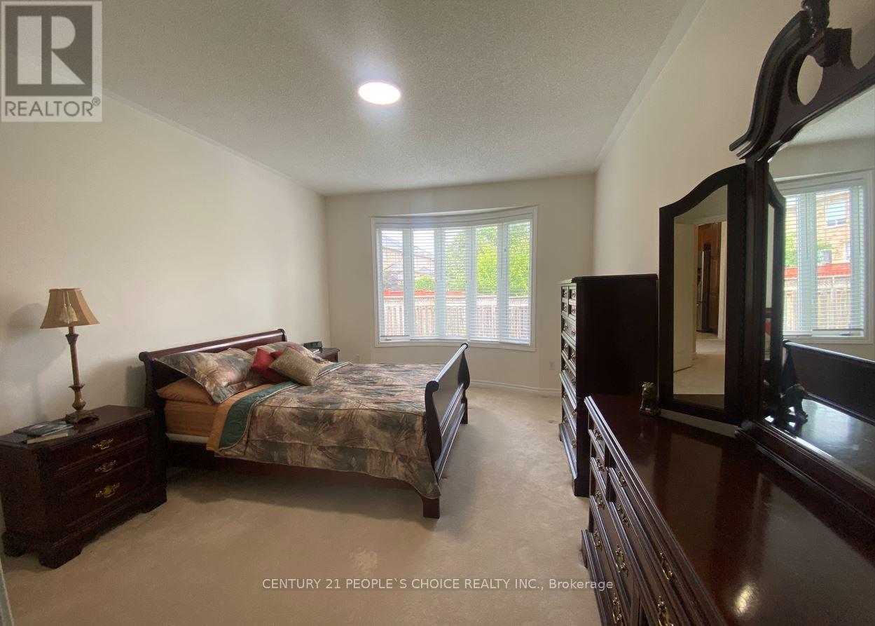 A bedroom with a bed, dresser, and mirror.