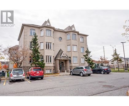 A large apartment building with a parking lot in front of it.
