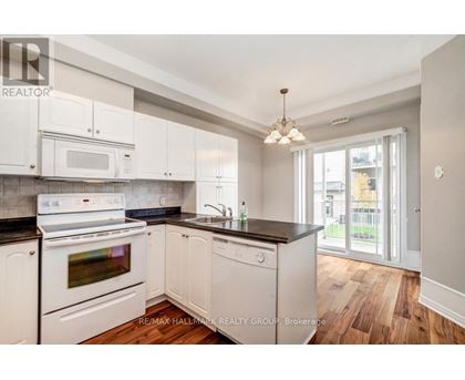 A kitchen with white appliances and cabinets.