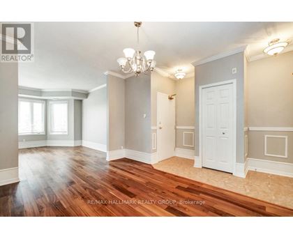 A room with a chandelier and a door.