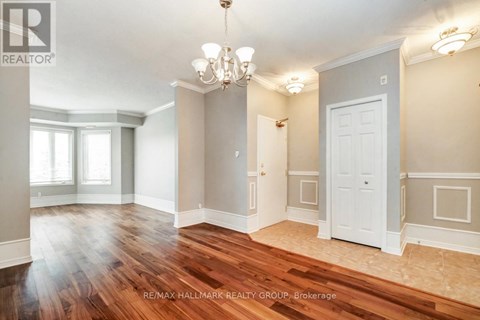 A room with a chandelier and a door.