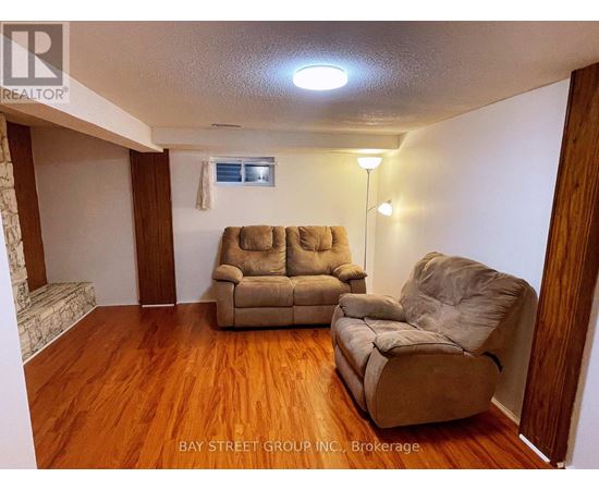A living room with two couches and a chair.