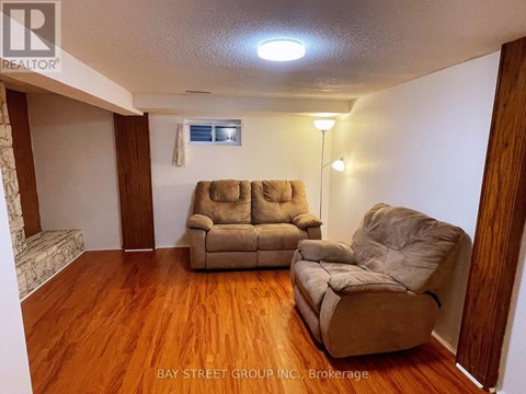A living room with two couches and a chair.